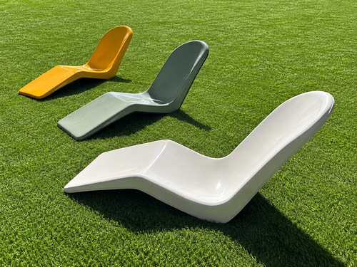 Immersa fiberglass lounge chairs on green turf