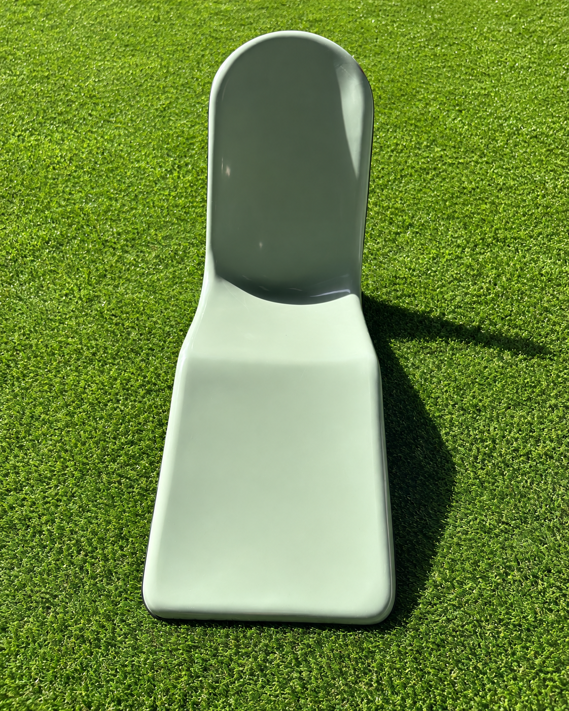 Immersa sage fiberglass lounge chair on turf