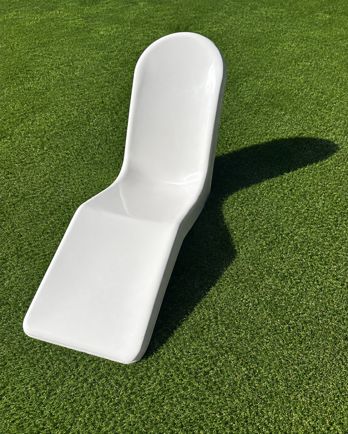 Immersa white fiberglass lounge chair on turf